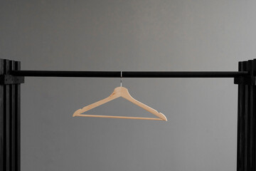 simple single clothes hanger on the rack, abstract simple fashion concept - obrazy, fototapety, plakaty
