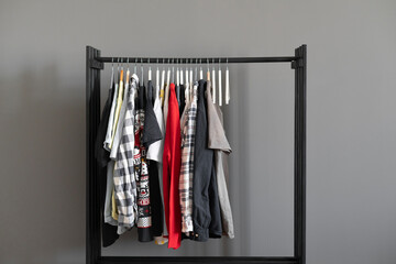 simple minimalistic clothes rack with some textile on the hangers