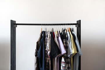 simple minimalistic clothes rack with some textile on the hangers