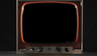 A retro vintage tv set, with a blank black screen (turned off).
