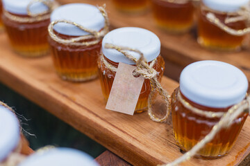 Honey glass jars, wedding souvenirs and sweets, bottled honey. bees, stock