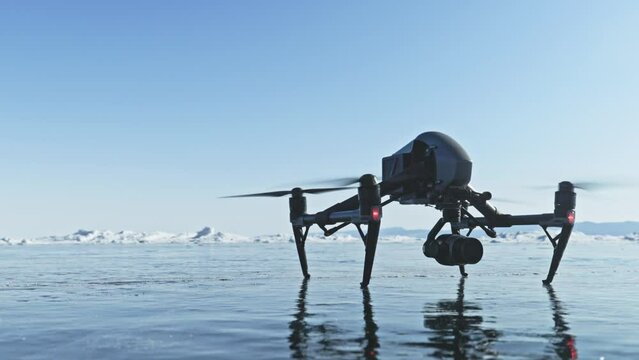 Professional drone takes off into the air from the ice
