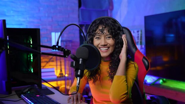 Holiday concept of 4k Resolution. Asian women are hosting an online radio program. disk jockey. DJ talking on the microphone.