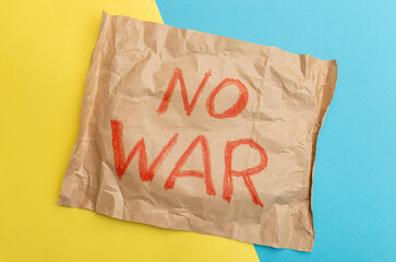 Sheet of craft paper with red color inscription No war. Crisis, peace, stop aggression