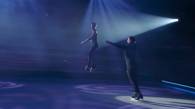 Throw phase structure in figure skating,run-up, preparation and execution of female partner repulsion, her flight in air in grouping, woman ungrouping, landing and graceful exit of both.Slow motion.