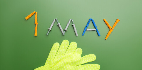 International Workers' Solidarity Day, 1 May concept. work gloves and Text 1 may on the green background. Happy labour day