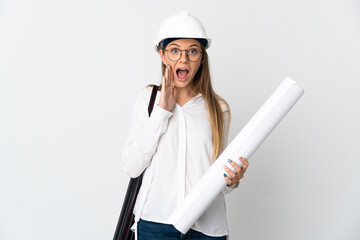 Young Lithuanian architect woman with helmet and holding blueprints isolated on white background with surprise and shocked facial expression