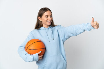 Young Lithuanian woman playing basketball isolated on white background giving a thumbs up gesture