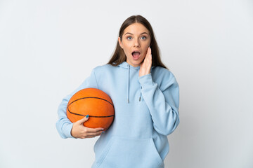 Young Lithuanian woman playing basketball isolated on white background with surprise and shocked facial expression