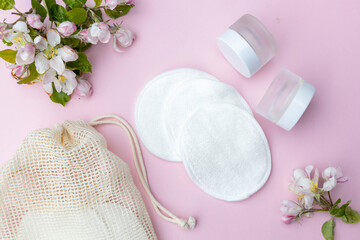 Reusable cotton make-up remover wipes in a cloth pouch. Reusable cotton pads with jars for cosmetics. Zero waste concept. © Larisa
