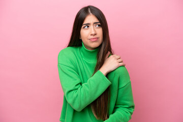 Young caucasian woman isolated on pink background suffering from pain in shoulder for having made an effort