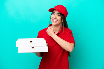 Pizza delivery woman with work uniform picking up pizza boxes isolated on blue background...