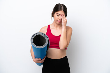 young sport woman going to yoga classes while holding a mat isolated on white background with tired and sick expression