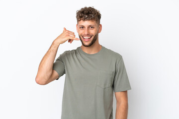 Young caucasian handsome man isolated on white background making phone gesture. Call me back sign