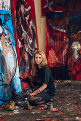 Female painter artist painting and creating her art in a creative studio