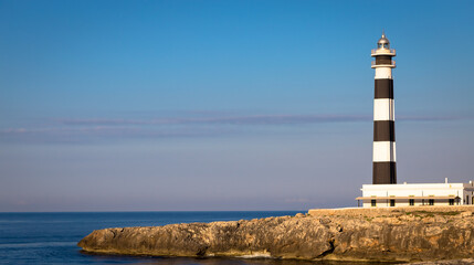 Scenic Artrutx Lighthouse at sunset in Minorca, Spain