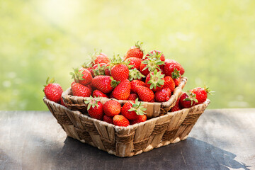 Strawberries in a basket on a wooden table