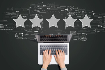Rating star concept with person using a laptop computer