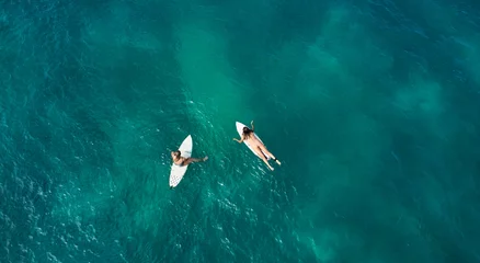 Fototapeten Aerial view of the ocean and surfer girls. Surfing in Midigama. Sri Lanka © Dima Anikin