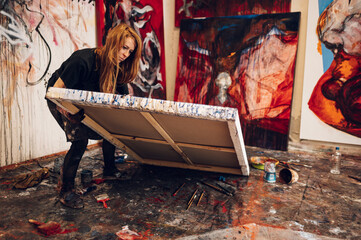 Female painter artist painting and creating her art in a creative studio