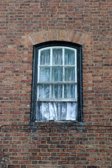 Old Arched Wooden Window in Brick Wall  