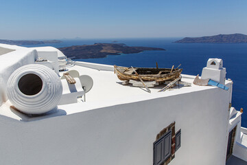 Historical boat on top of the roofs at Santorini island, Greece.