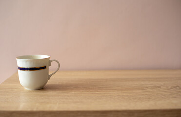 A cup of coffee or tea on a wooden table