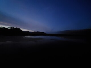 sunset over wetlands and mountain ridge