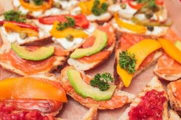 Catering table, beautifully decorated banquet with variety of with different food snacks and appetizers on corporate birthday party event or wedding celebration, delicatessen setting
