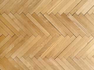 Wooden parquet top view. Herringbone natural parquet