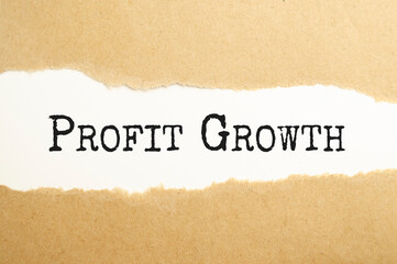 Plakat The text profit GROWTH behind torn brown paper