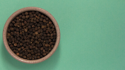 Not ground pepper. Place for text. On a turquoise background.