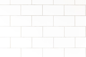 Naklejka premium White rectangle mosaic tiles texture background. Classic white metro tile. Long wide picture.