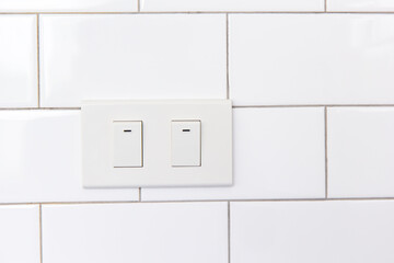 Modern double light switch on white wall with copy space