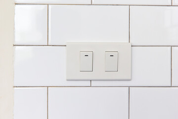 Modern double light switch on white wall with copy space