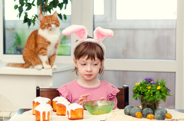 The girl decorates Easter cakes.  Easter preparations.