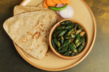 Bhindi masala or ladies finger fry served with indian roti chapati or Indian Flat bread