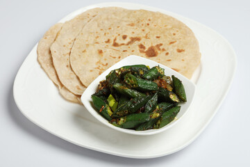 Bhindi masala or ladies finger fry served with indian roti chapati or Indian Flat bread