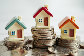 House on stack of coins, Investment property finance concept.
