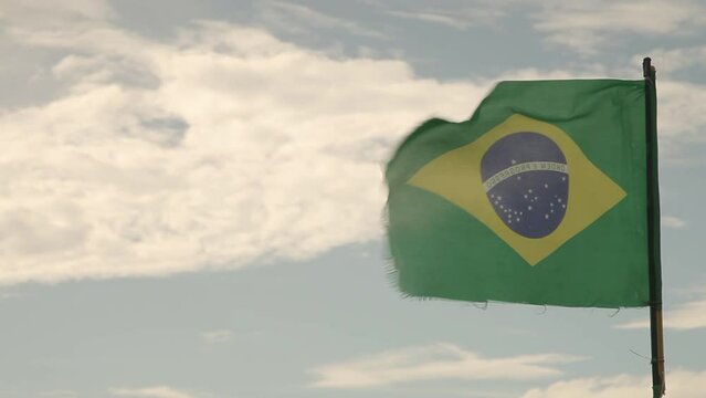 Brazilian flag flying on a moving boat crossing the river. Brazilian boat crossing the lake. Brazil concept. Nation concept.
