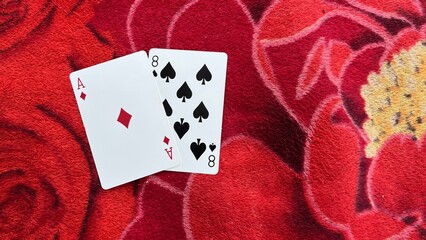 Casino playing card on the table isolation background at Casino Border, Kampong Rou District, Svay Reing Province, Cambodia, Casino element, Casino poker over red background.