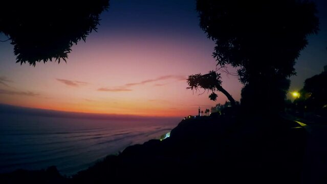 sunset sunrise over seaside time lapse, panorama dark red dramatic clouds Lighthouse lima peru coast