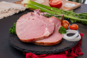 Raw pork chop with vegetables on table