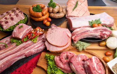 Raw various pork on table with fresh herbs