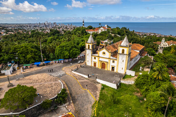 Aerial view of the city of Olinda in Alto da Sé with church, houses, sea and movement of people.