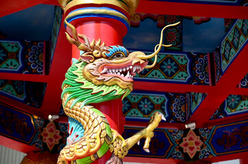 Closeup of Tha Colorful Dragon Decoration On the black wall background at Thai Temple at Thailand.