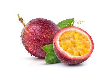 Purple passion fruit (Passiflora edulis) with cut in half and green leaves isolated on white...