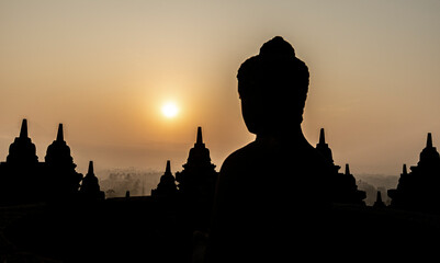 Silhouette of buddha statue at Borobudur temple during sunrise