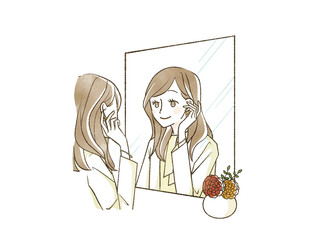 鏡を見て身だしなみを整えている女性