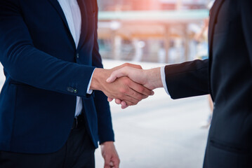 Businessman handshake with partner at the outdoor for greeting, dealing, collaboration and teamwork concept.